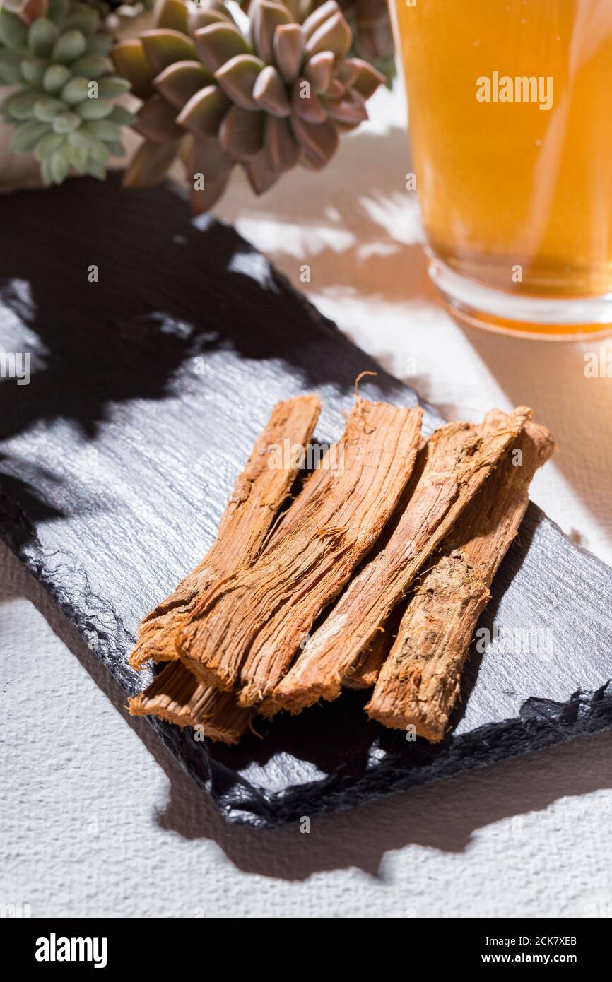 Bark and tea of cat's claw plant on white background Uncaria