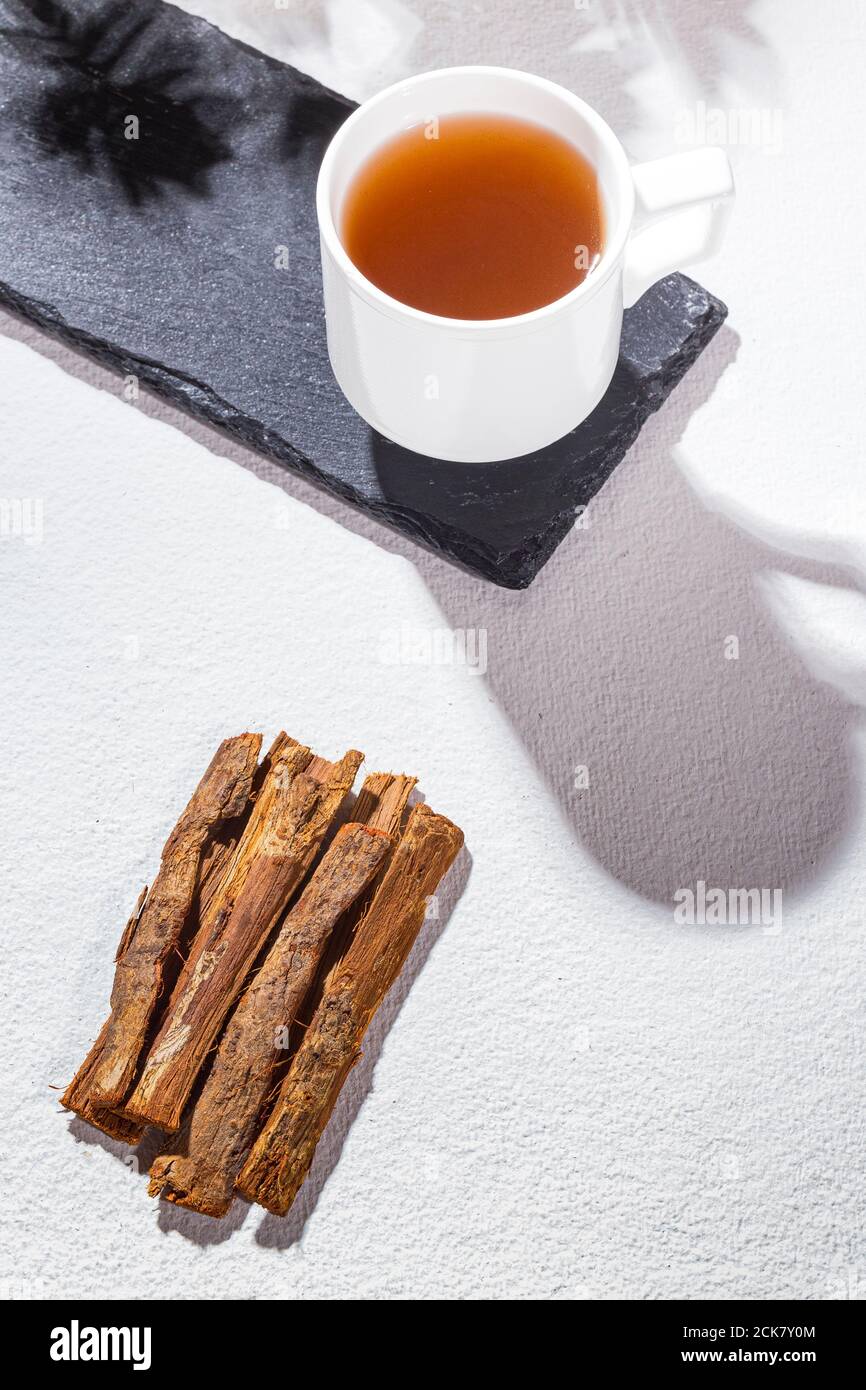 Bark and tea of cat's claw plant on white background Uncaria