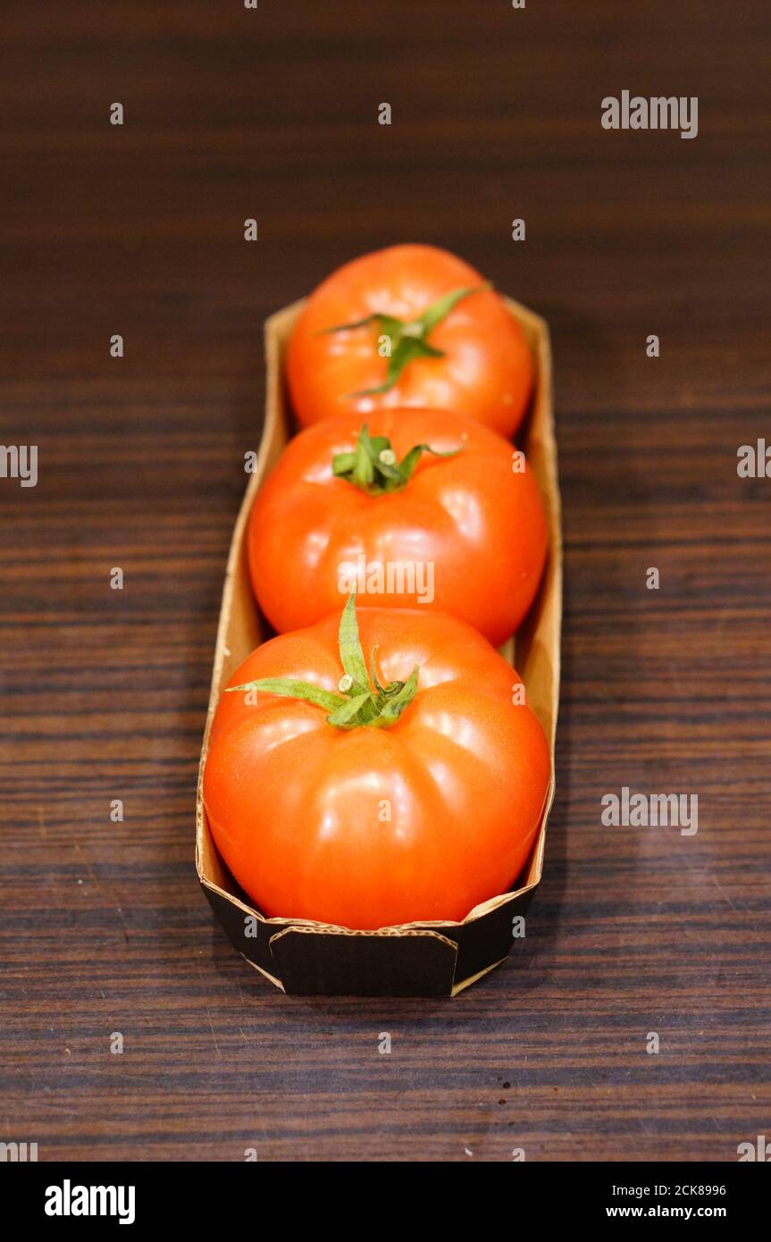 Closeup shot of the ripe red tomatoes in the paper box Stock Photo - Alamy