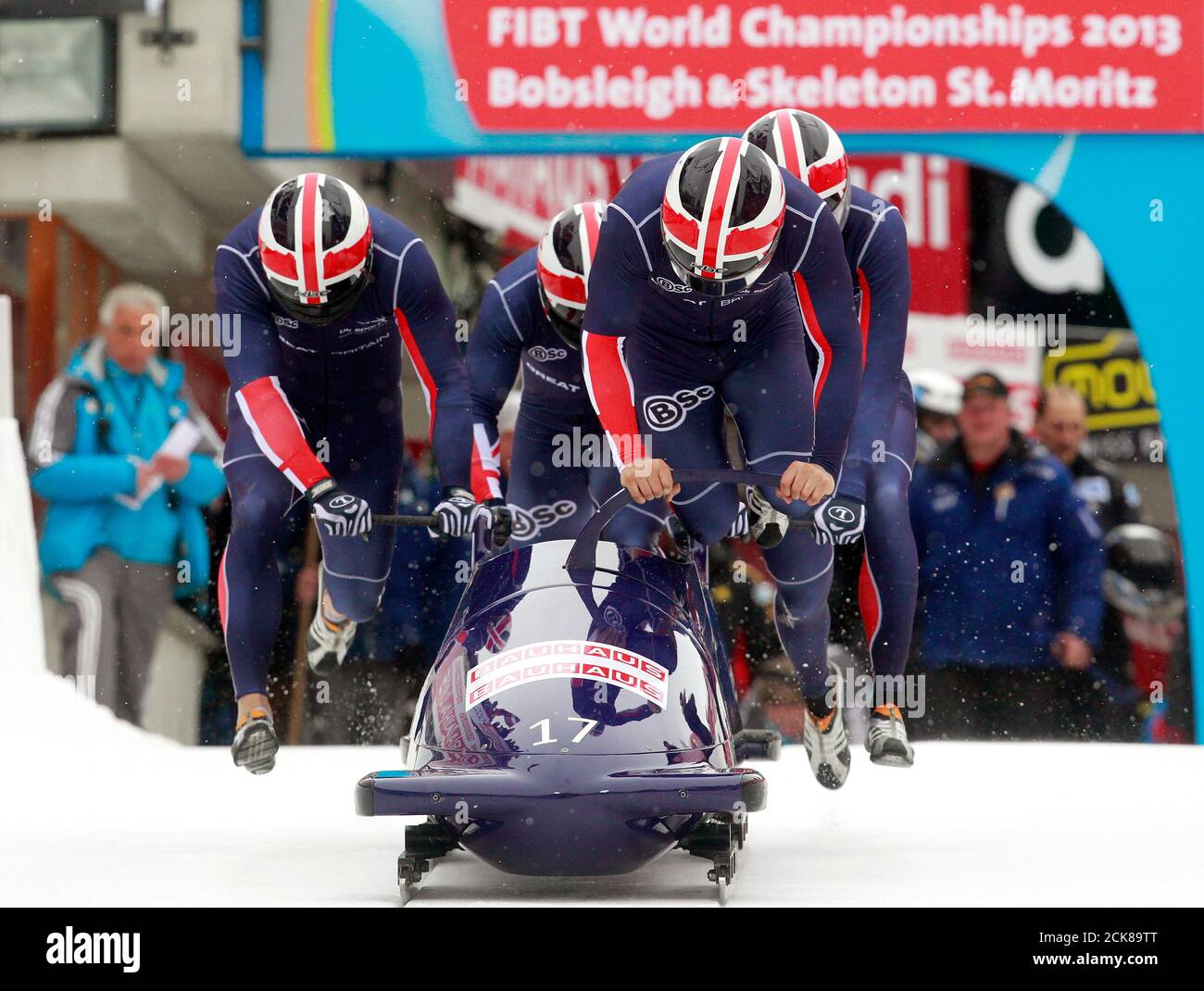 Britain's team pilot John James Jackson (front), Stuart Benson, Bruce Tasker  and Joel Fearon start on the natural ice track during the first run of the  4-men competition at the FIBT Bobsleigh