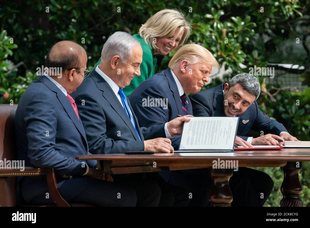 U.S. Chief of Protocol Cam Henderson assists President Donald J. Trump, Minister of Foreign Affairs of Bahrain Dr. Abdullatif bin Rashid Al-Zayani, Israeli Prime Minister Benjamin Netanyahu and Minister of Foreign Affairs for the United Arab Emirates Abdullah bin Zayed Al Nahyan with the documents during the signing of the Abraham Accords Tuesday, September 15, 2020, on the South Lawn of the White House. (USA) Stock Photo