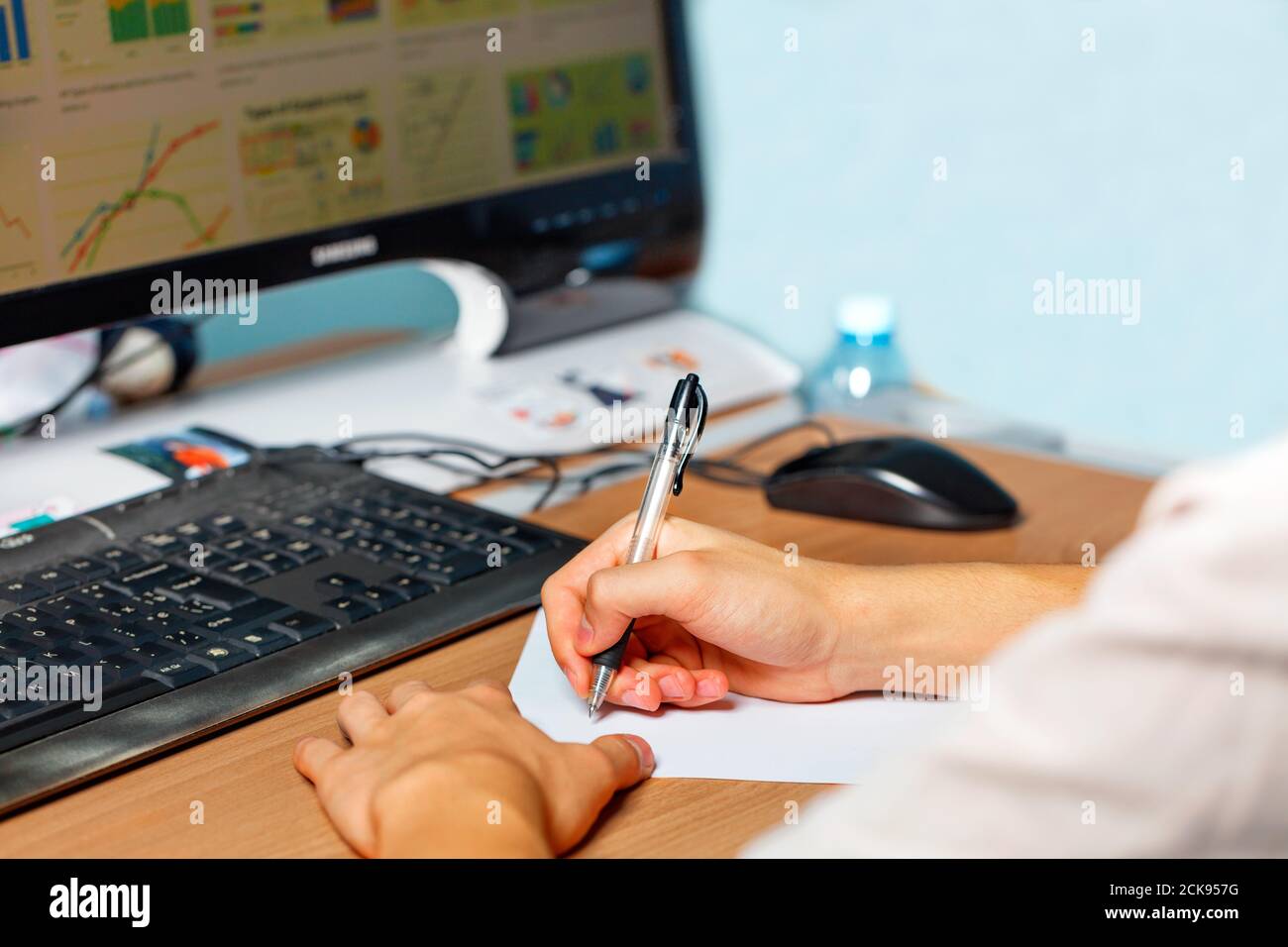 Young man preparing to take lecture notes, working at the computer, e-learning concept. Stock Photo