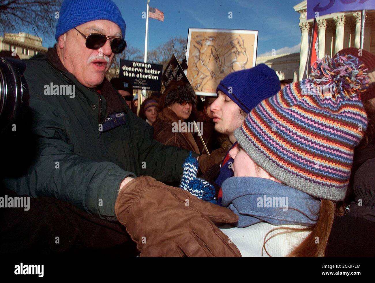 An unidentified anti-abortion demonstrator (L) shoves Amy Savarese, an American University student, of Harrisburg, PA. during a demonstration in front of the U.S. Supreme Court in Washington January 22, 2003. Activists on both sides of the abortion debate rallied on Wednesday to mark the 30th anniversary of the U.S. Supreme Court ruling legalizing abortion. Three decades after the high court decision on Roe v. Wade, abortion rights supporters worry that the right to terminate pregnancy may be endangered. Republicans hold the White House and majorities in both houses of Congress, with a slim 5- Stock Photo