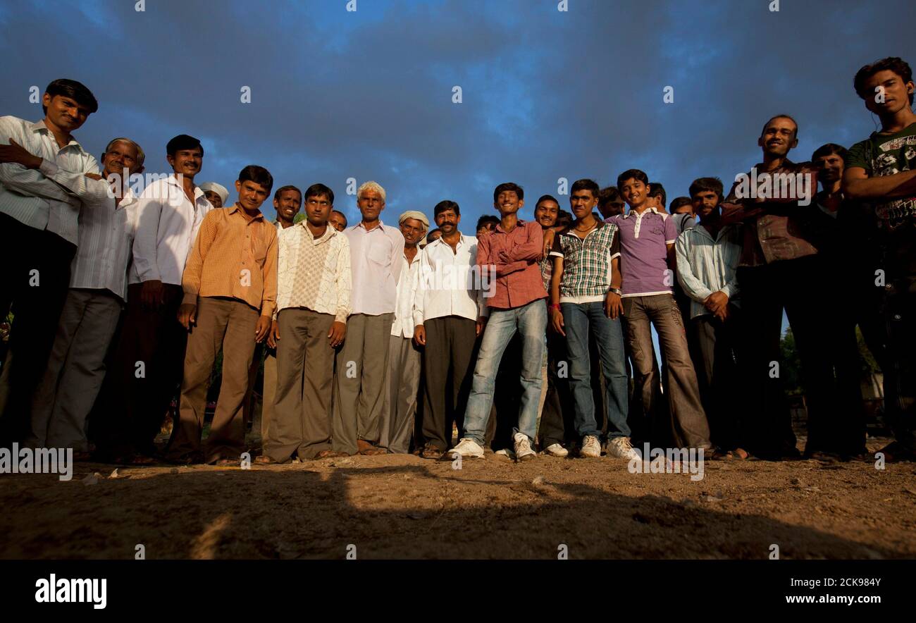 A group of mostly unmarried men pose for a photograph in the remote village of Siyani, about 140km (86 miles) west of Gujarat's capital Ahmedabad, October 5, 2011. Siyani is typical of many Indian villages and may be an indicator of things to come as India's male to female ratio declines. The village has some 350 unmarried men over the age of 35 - and hundreds more under 35 - because there aren't enough women to marry. Many women have also left to look elsewhere for grooms with more money and better prospects. Census data released earlier this year revealed there are 914 girls for every 1,000  Stock Photo