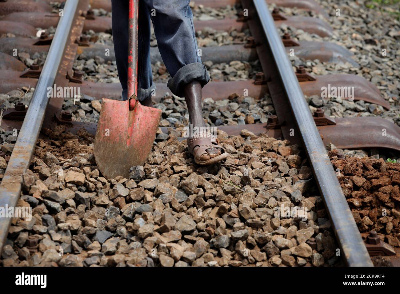 A worker fixes a section of the SGR railway track, near the town of Kiu  south of Nairobi, Kenya, December 16, 2019. REUTERS/Baz Ratner SEARCH " MOMBASA–NAIROBI TRAIN" FOR THIS STORY. SEARCH "WIDER