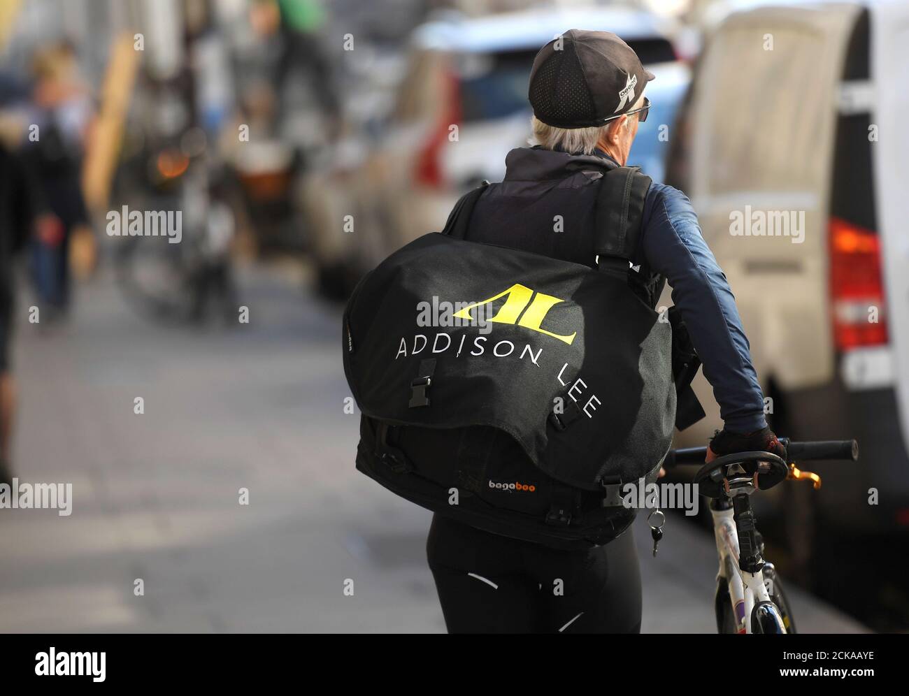 An Addison Lee courier pushes a bicycle in central London, Britain  September 22, 2017. REUTERS/Toby Melville Stock Photo - Alamy