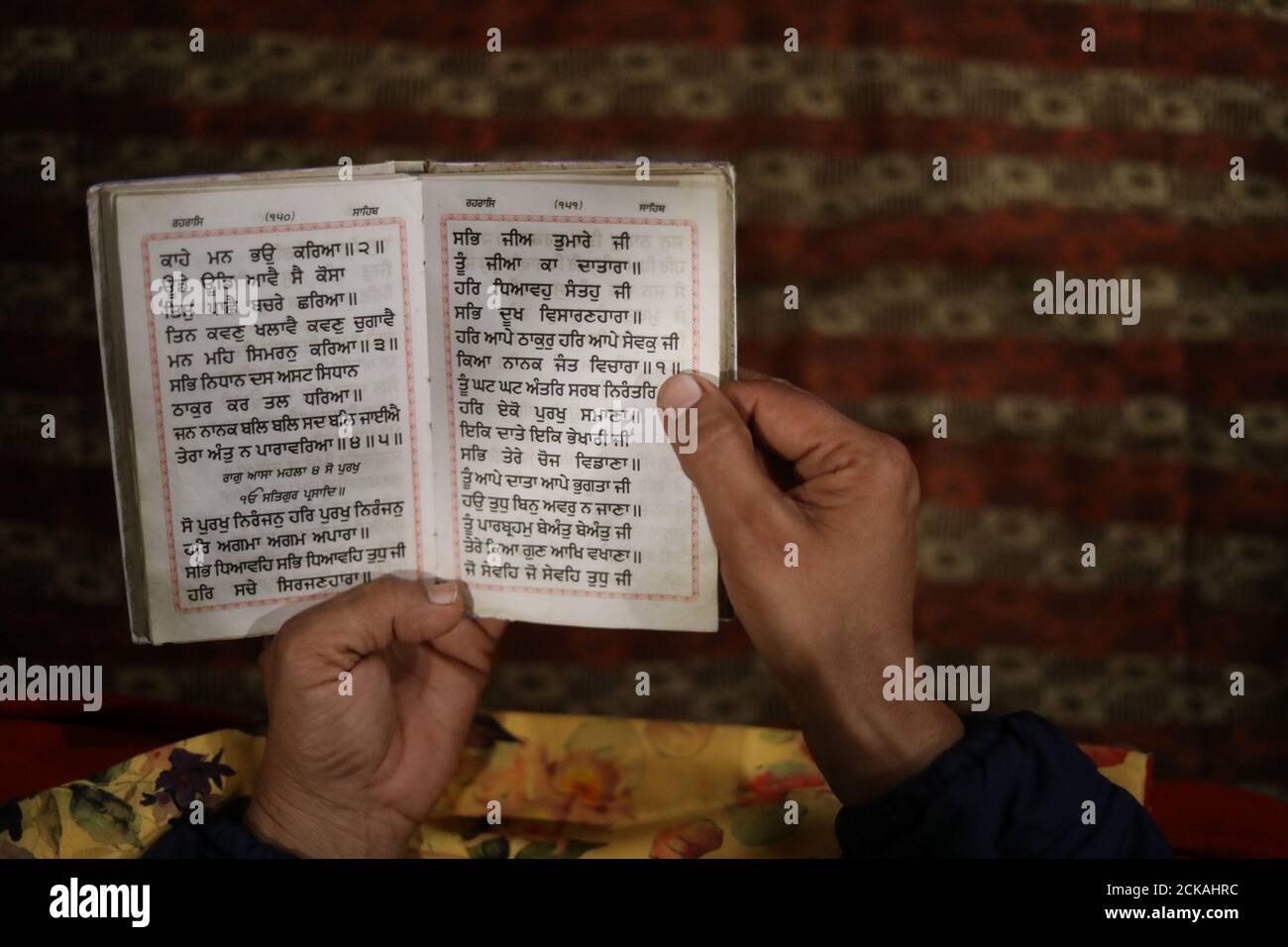 Baljit Kaur who says her NRI (non-resident Indian) husband abandoned her, reads a holy scripture at a Gurudwara (a Sikh place of worship) in Fatehgarh Sahib, Sirhind, Punjab, India, March 25, 2019. 'I never imagined a woman of my age would end up like this,' says Kaur who works as an assistant sub inspector for the Punjab police. 'I thought my life would be different,'. REUTERS/Anushree Fadnavis      SEARCH 'RUNAWAY HUSBANDS' FOR THIS STORY. SEARCH 'WIDER IMAGE' FOR ALL STORIES. Stock Photo
