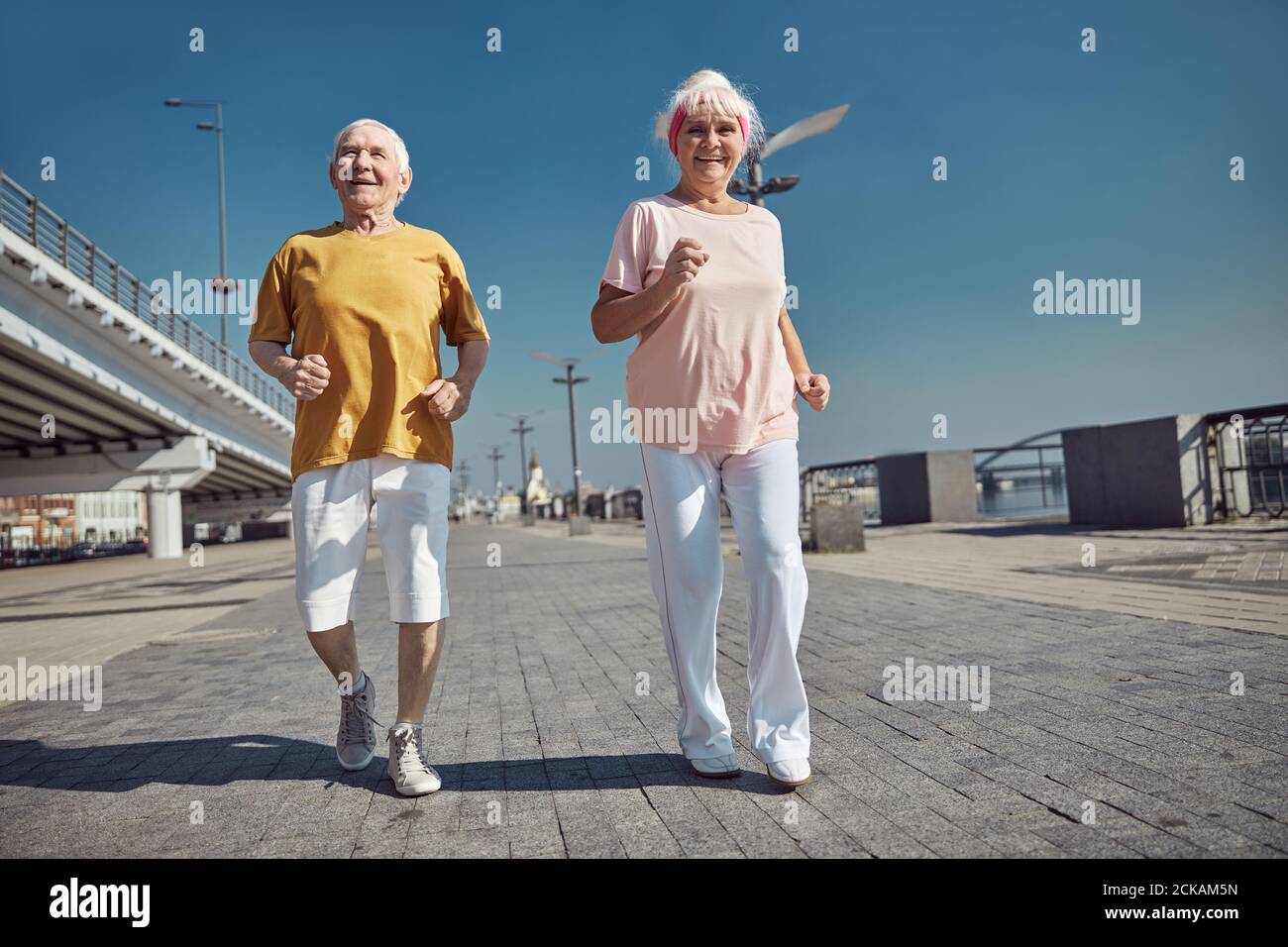 Elderly woman and a man working out together Stock Photo