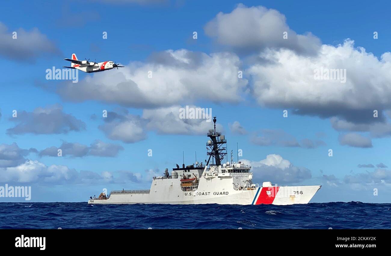 The crews of the Coast Guard Cutter Kimball (WMSL 756) and an Air Station Barbers Point HC-130 Hercules airplane conduct joint operations in the Pacific August 14, 2020. The crews were participating in the multi-country maritime Operation Nasse designed to prevent Illegal, unregulated or unreported (IUU) fishing in Oceania. (U.S. Coast Guard photo courtesy of the Coast Guard Cutter Kimball/Released) Stock Photo