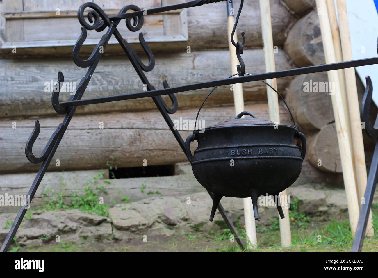 Hiking kitchen, cast-iron pot on the stand. Stock Photo