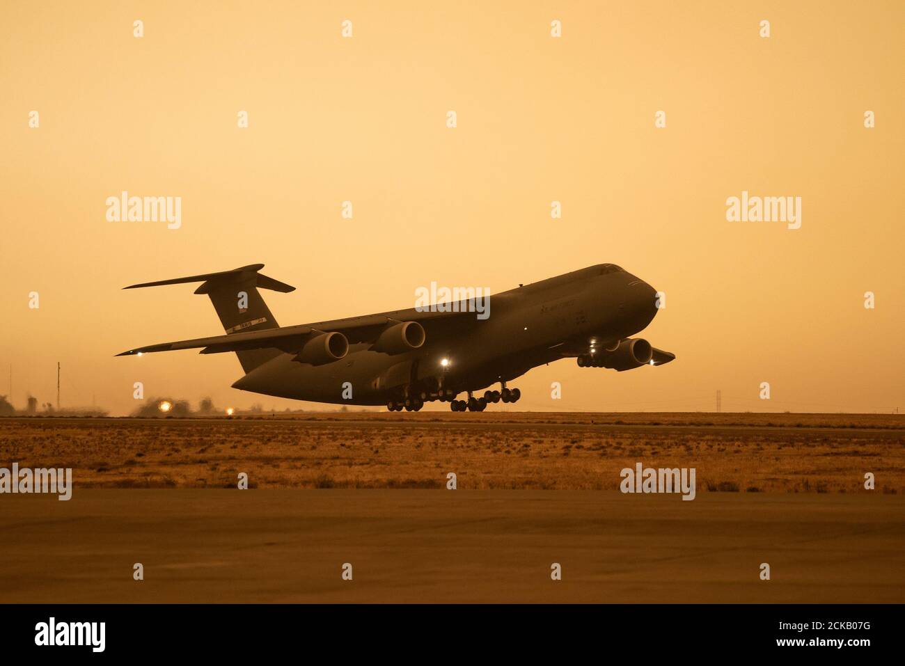 A C-5M Super Galaxy takes off at Travis Air Force Base, California, Sept. 9, 2020. Wildfires across California propelled smoke and ash into the troposphere, impacting air quality. (U.S. Air Force photo by Heide Couch) Stock Photo