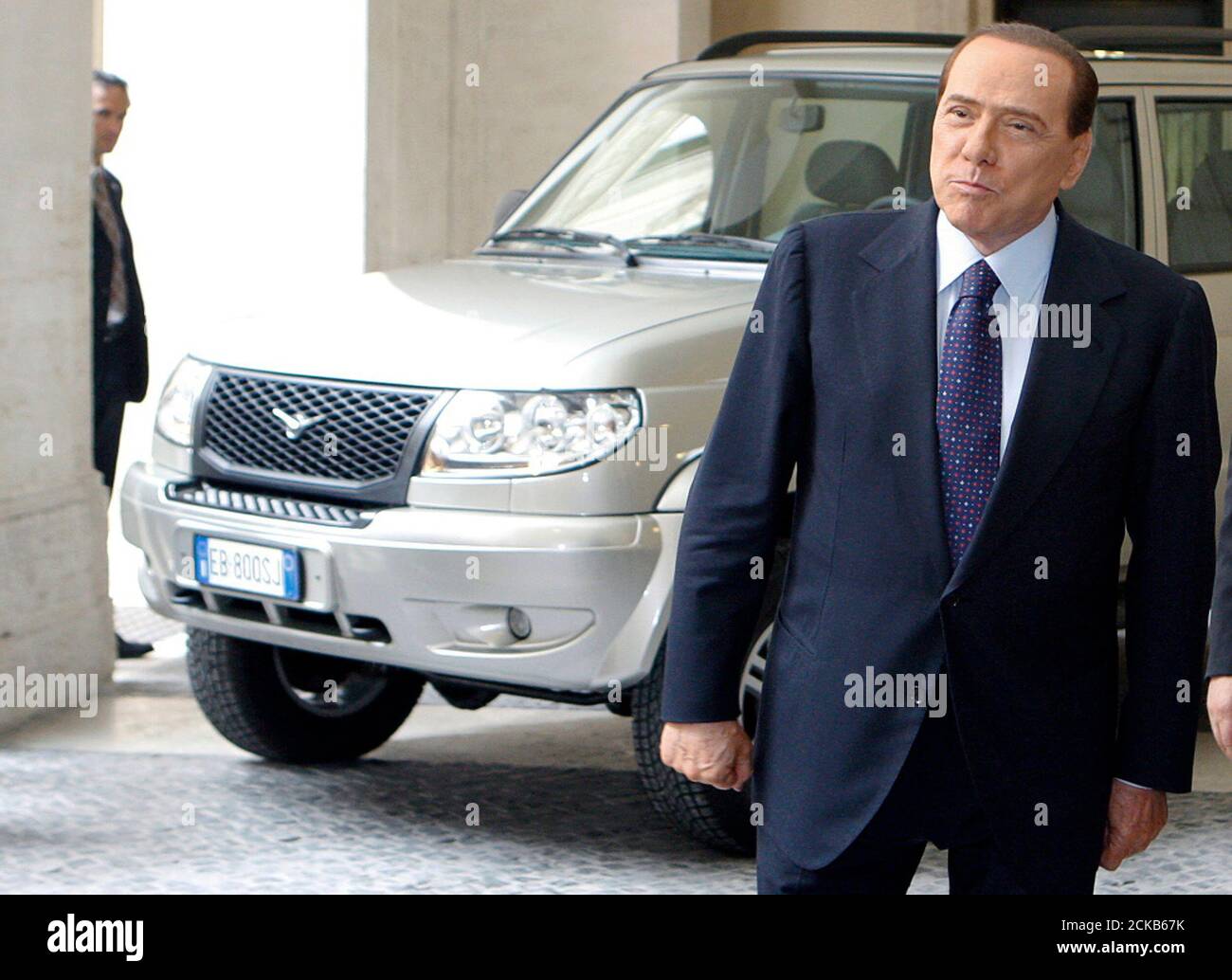 Italy's Prime Minister Silvio Berlusconi poses near the "Patriot", a new  car model by auto maker Sollers, at the Chigi Palace in Rome April 23,  2010. The new sport utility vehicle is
