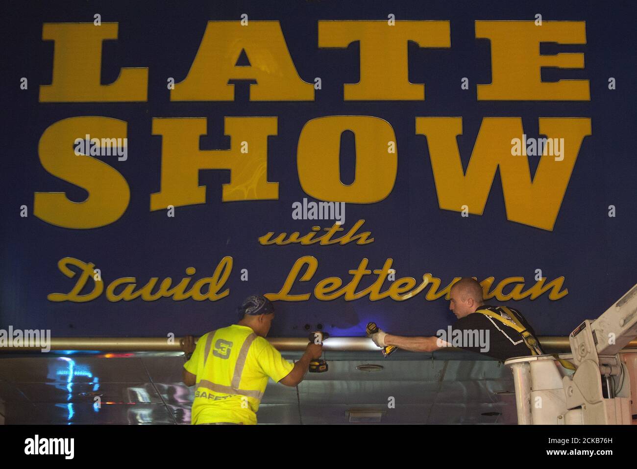 Workers remove the marquee from the Ed Sullivan Theater where "The Late Show" with David Letterman used to tape in the Manhattan borough New York May 27, 2015. The taping and broadcast of the final edition of "The Late Show" was May 20, and workers are now slowly transforming the theater for the show's new host Stephen Colbert which will premiere on September 8, 2015. REUTERS/Carlo Allegri Stock Photo