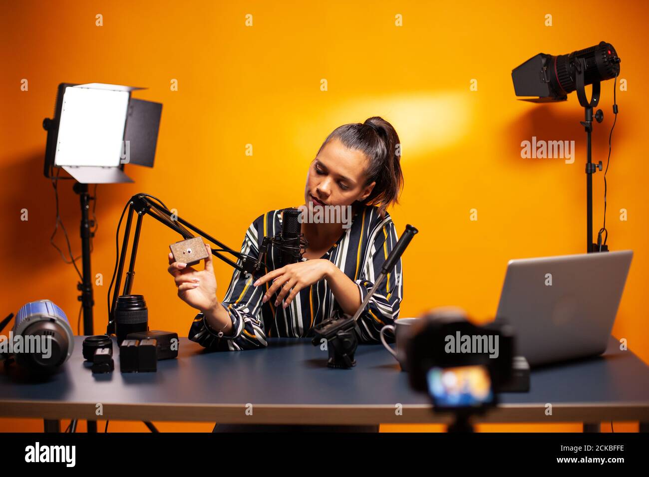 Content creator recording videoblog about fluid head for tripod. Social