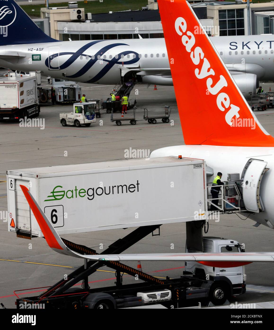A Gate Gourmet Staff Part Of Swiss Airline Catering Firm Gategroup Holdings Delivers Goods To An Easyjet Commercial Airplane At Cointrin Airport In Geneva Switzerland April 13 16 Picture Taken Through A