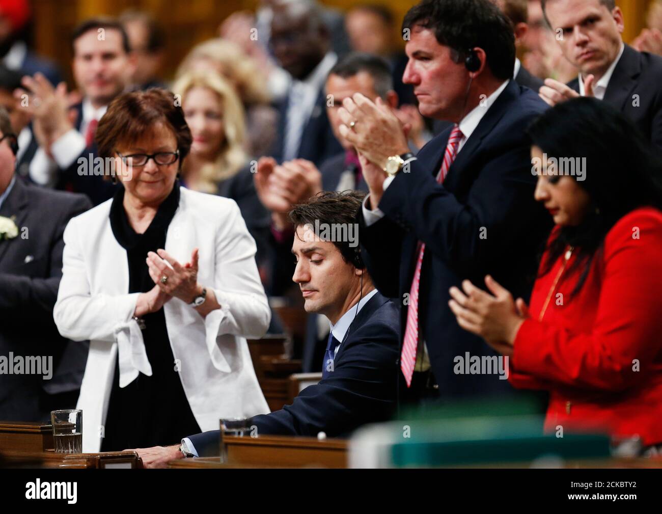 Liberal MPs applaud after Canadian Prime Minister Justin Trudeau delivered an apology in the House of Commons in Ottawa, Ontario, Canada after a physical alteration the previous day. REUTERS/Chris Wattie Stock Photo