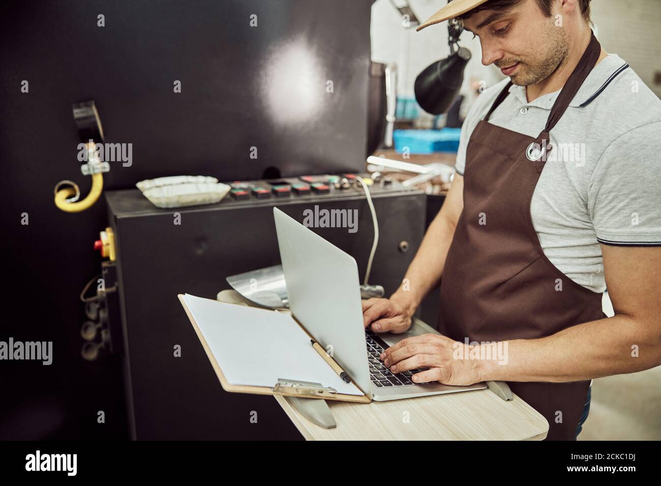 Handsome male worker using modern laptop at work Stock Photo
