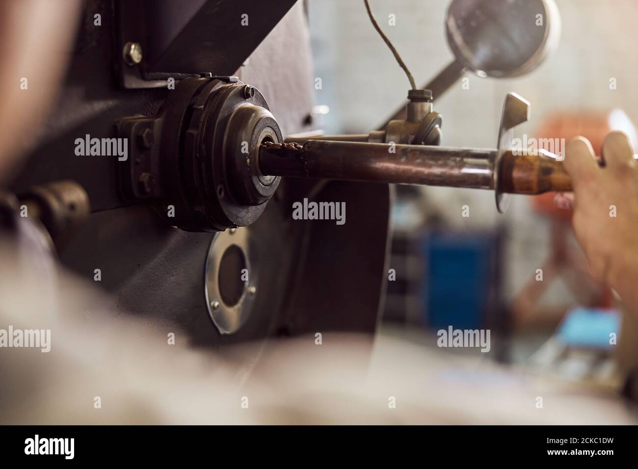 Male worker using industrial coffee roasting machine Stock Photo