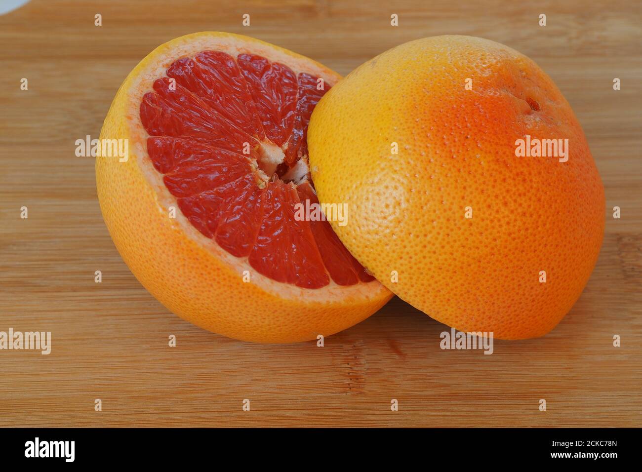 Fruits are citrus fruits. Red grapefruit cut in half Stock Photo Alamy