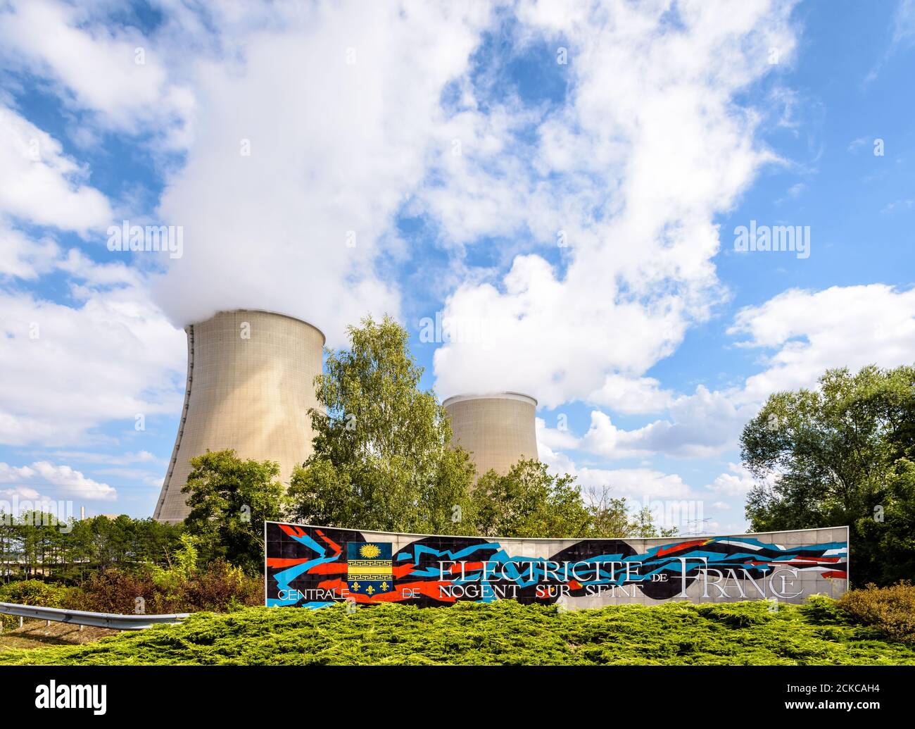 Welcome sign of the nuclear power plant of Nogent-sur-Seine, France, run by public electricity utility company EDF, and the two cooling towers. Stock Photo
