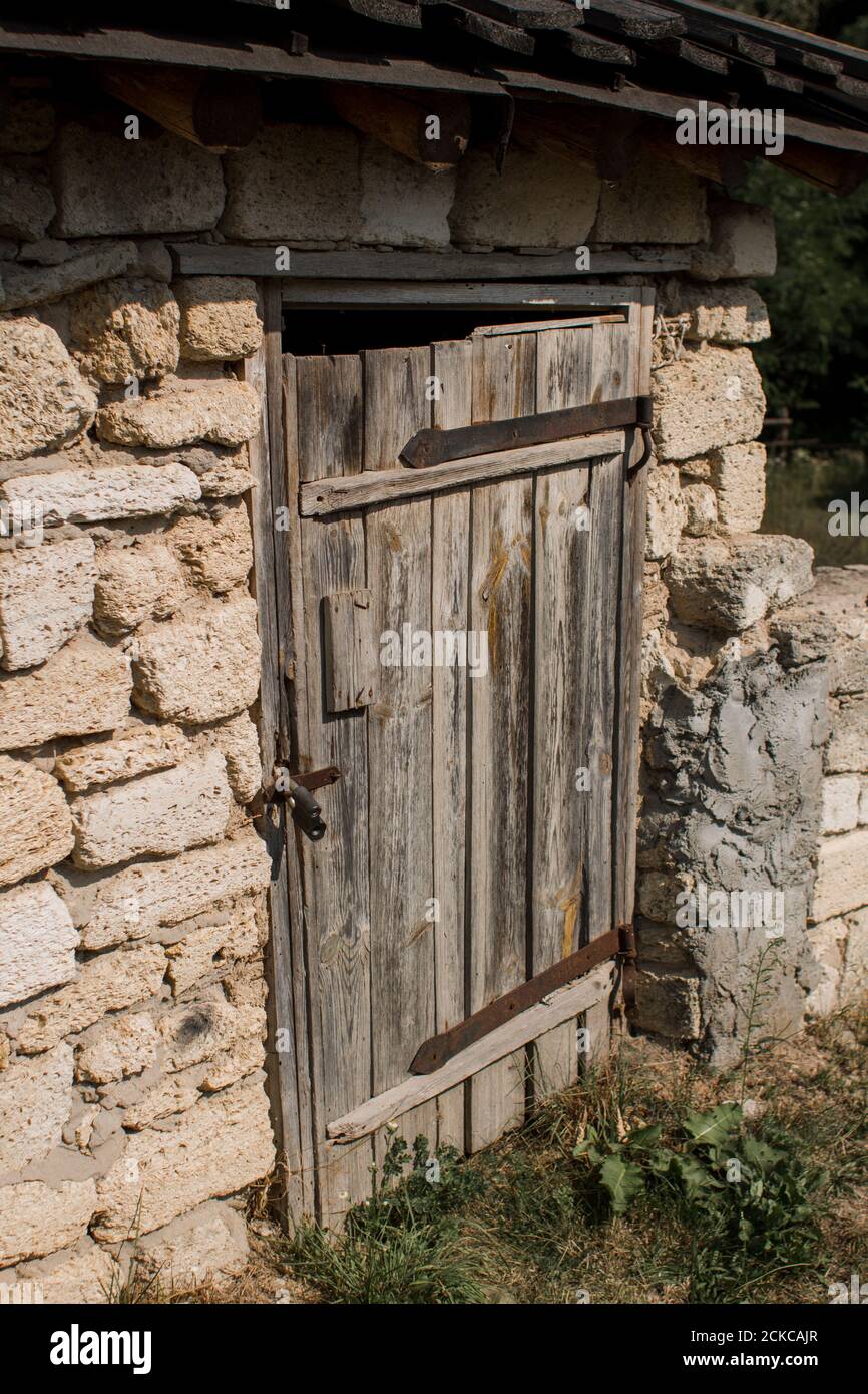 old wooden door in stone wall locked Stock Photo - Alamy
