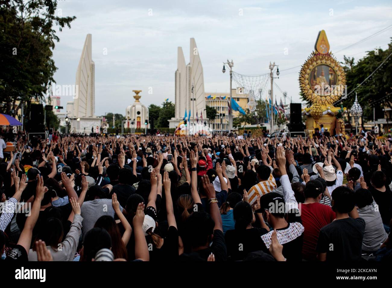 Three finger salutes are held up as thousands of protesters attend a demonstration against the government at Democracy Monument in Bangkok, Thailand on Sunday 16th, August 2020. Among the protesters' demands are calls for reform of Thailand's monarchy. (Photo - Jack Taylor) Stock Photo