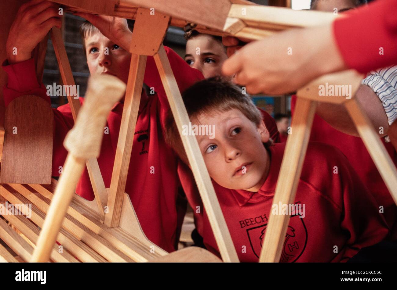 Children at Beech Hyde Primary School in Wheathampstead in Hertfordshire building a large scale biplane wit help from apprentices from British Aerospace. 29 March 1993. Photo: Neil Turner Stock Photo
