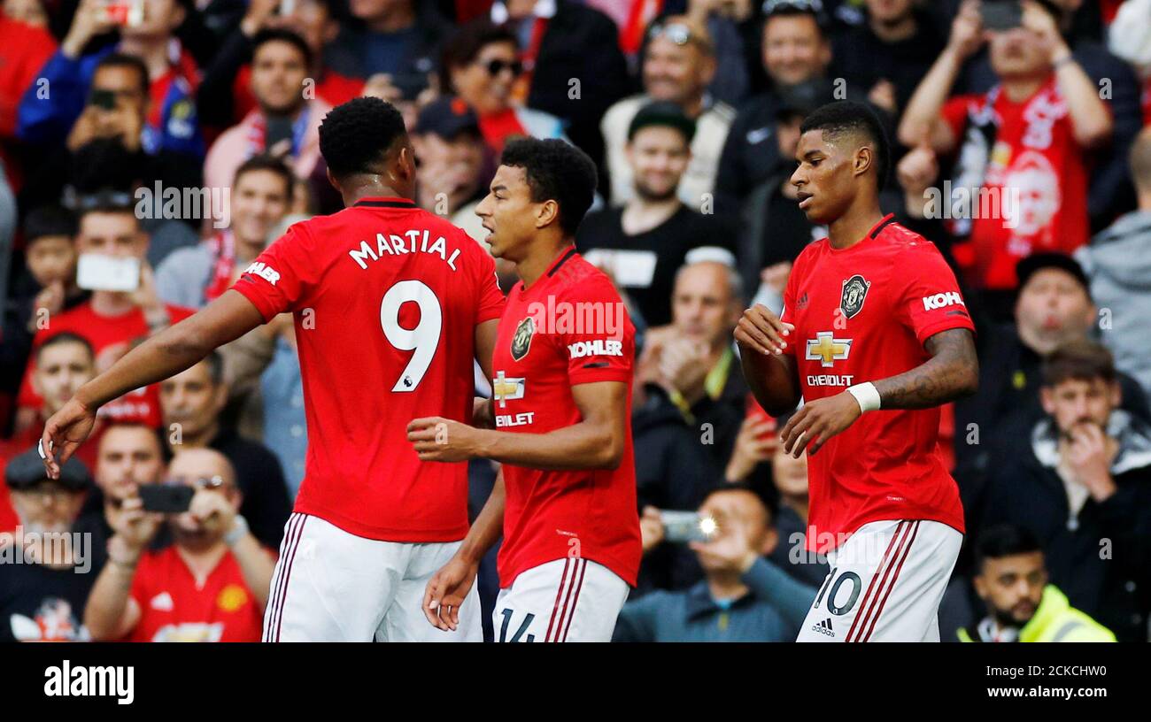 Soccer Football - Premier League - Manchester United v Chelsea - Old Trafford, Manchester, Britain - August 11, 2019  Manchester United's Marcus Rashford celebrates scoring their first goal with Anthony Martial and Jesse Lingard   REUTERS/Phil Noble  EDITORIAL USE ONLY. No use with unauthorized audio, video, data, fixture lists, club/league logos or 'live' services. Online in-match use limited to 75 images, no video emulation. No use in betting, games or single club/league/player publications.  Please contact your account representative for further details. Stock Photo