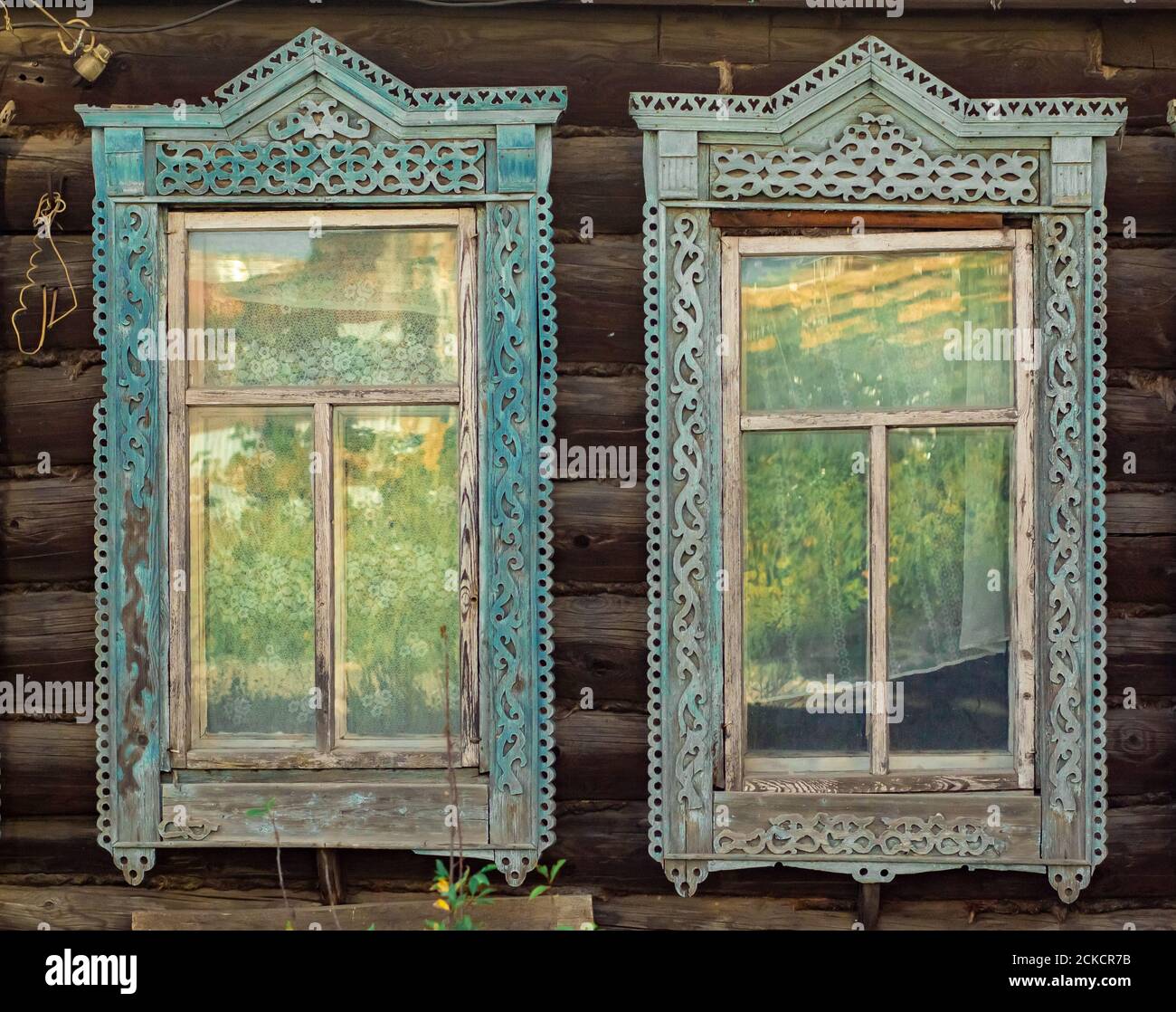 Windows of traditional wooden architecture in Russia. Windows of provincial cities. Stock Photo