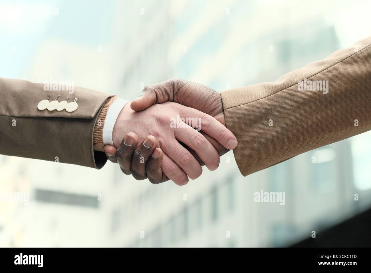 Close-up of business people shaking hands outdoors Stock Photo
