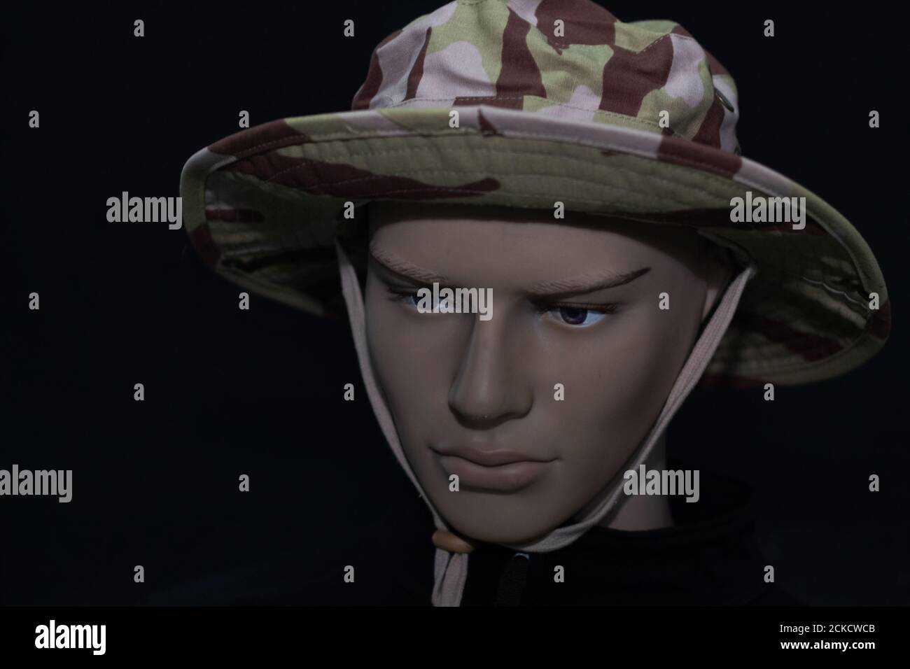 Mannequin face in a military cap isolated on a black background Stock Photo