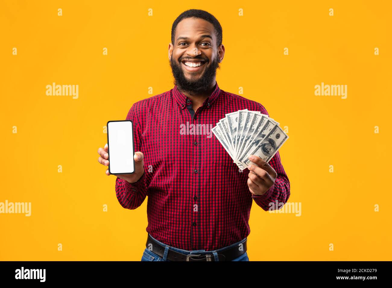 Afro guy holding mobile phone and bunch of money cash Stock Photo - Alamy