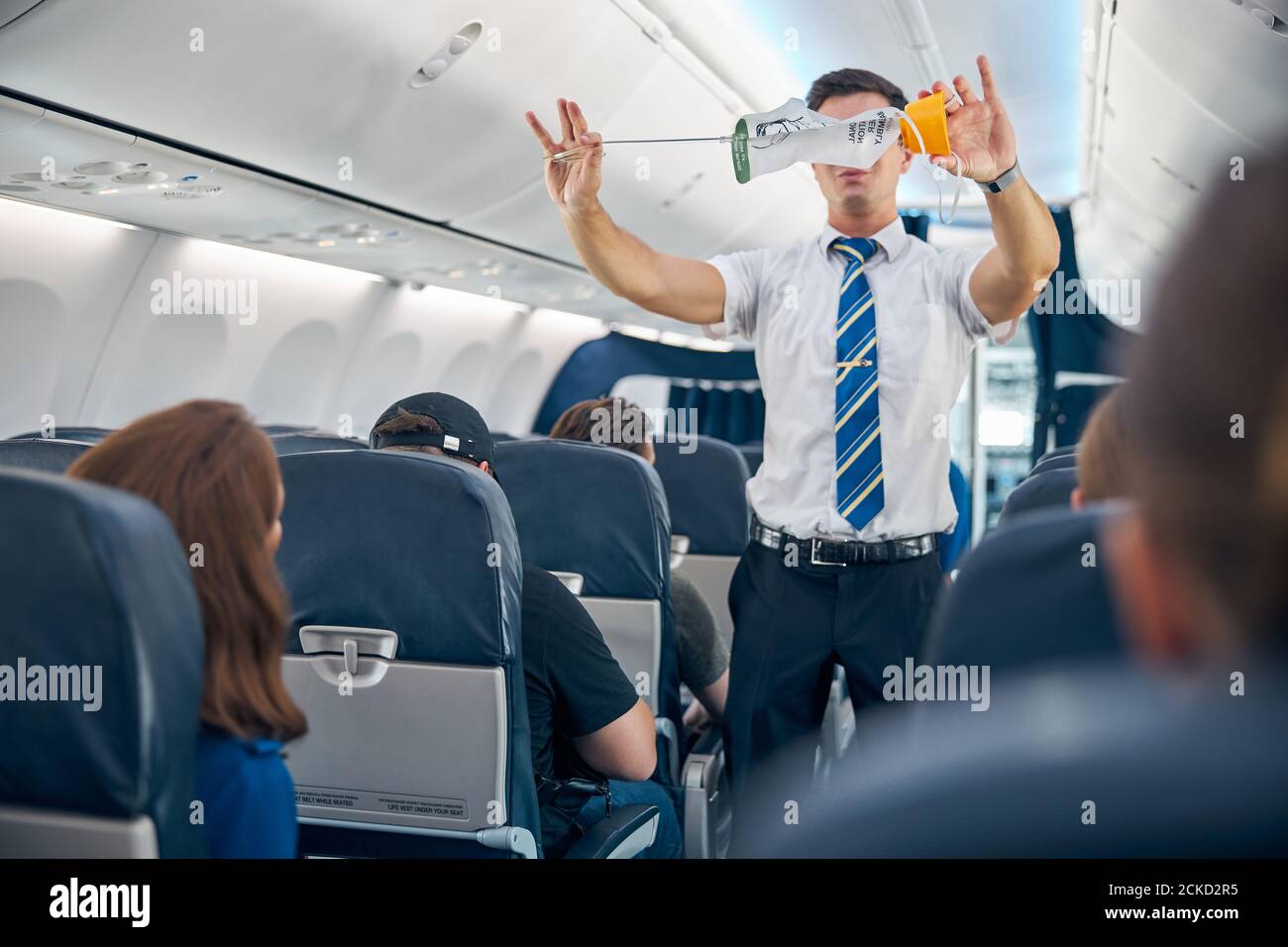 Waist up portrait of steward showing the safety rules and instructions