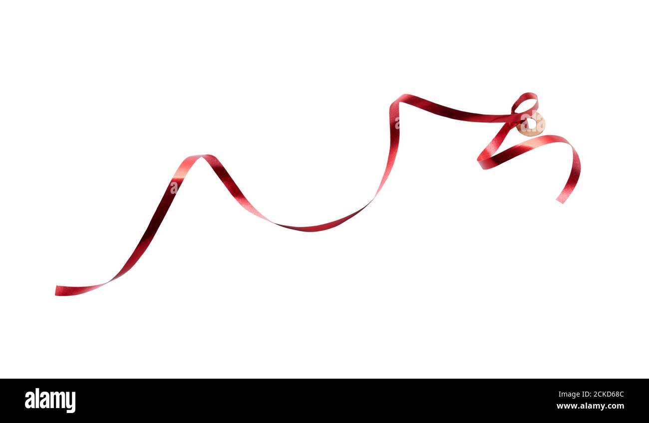 A thin curly red ribbon for Christmas and birthday present tag loop isolated against a white background. Stock Photo