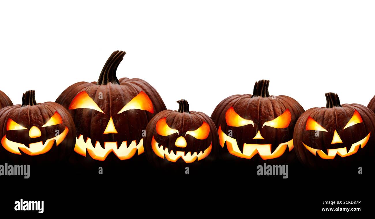 A group of five spooky halloween lanterns, Jack O Lantern, with evil face and eyes isolated against a white background. Stock Photo