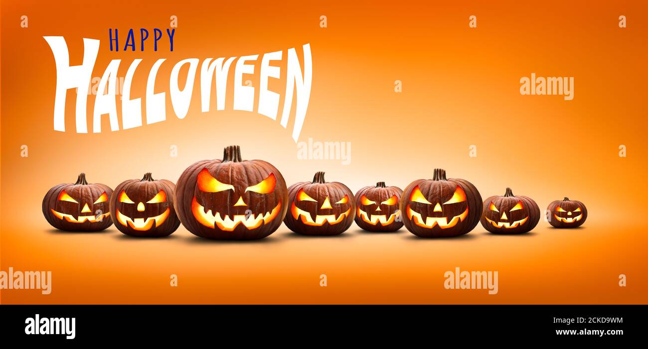 Nine halloween, Jack O Lanterns, with evil spooky eyes and faces isolated against a orange and yellow lit background with the words, Happy Halloween. Stock Photo