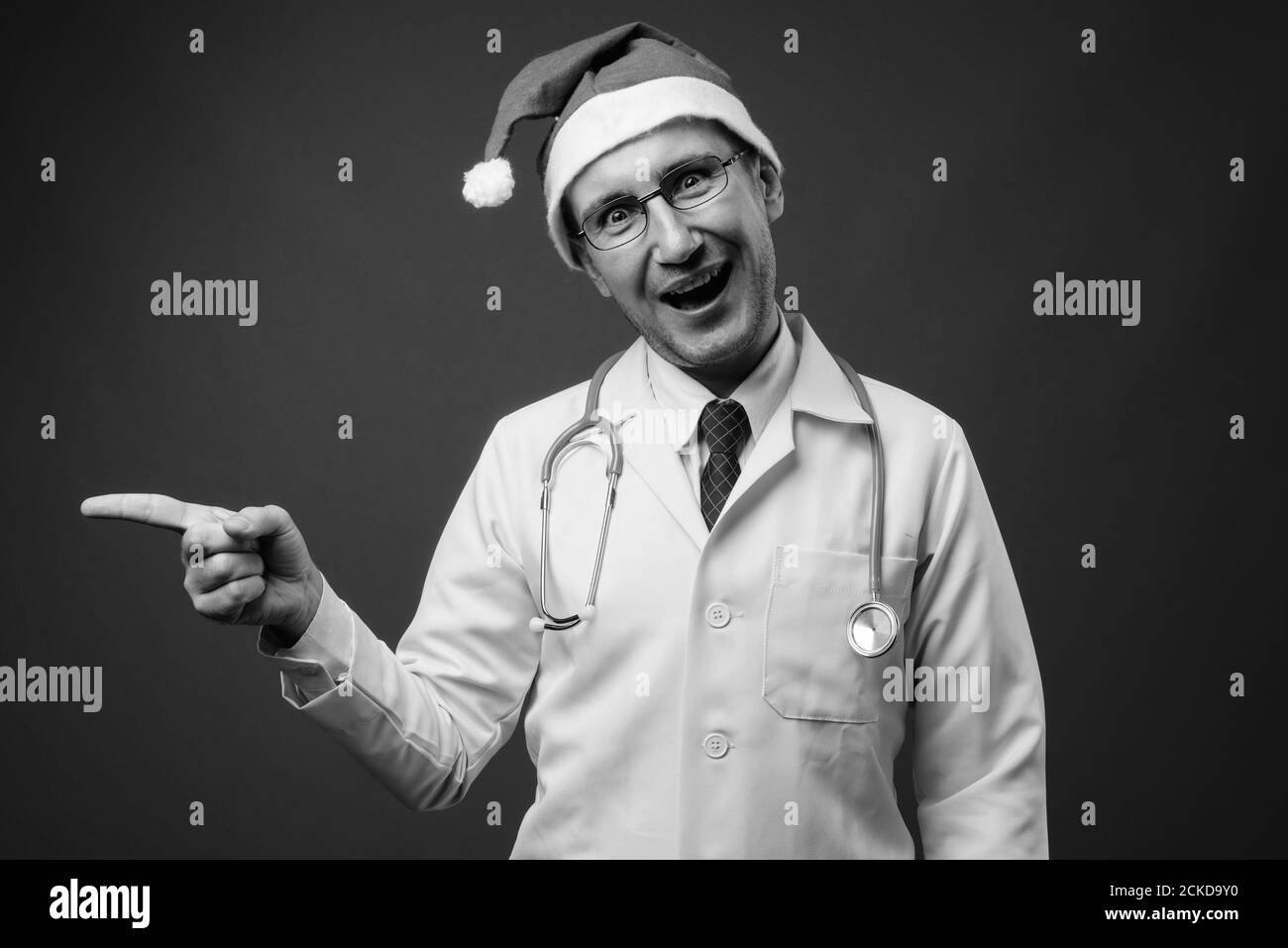Portrait of man doctor with Santa hat ready for Christmas Stock Photo