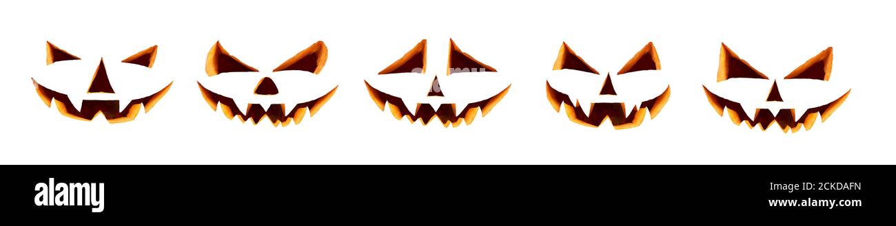 Five unlit halloween cut out faces isolated against a white background ready to be used on daytime pumpkins. Stock Photo