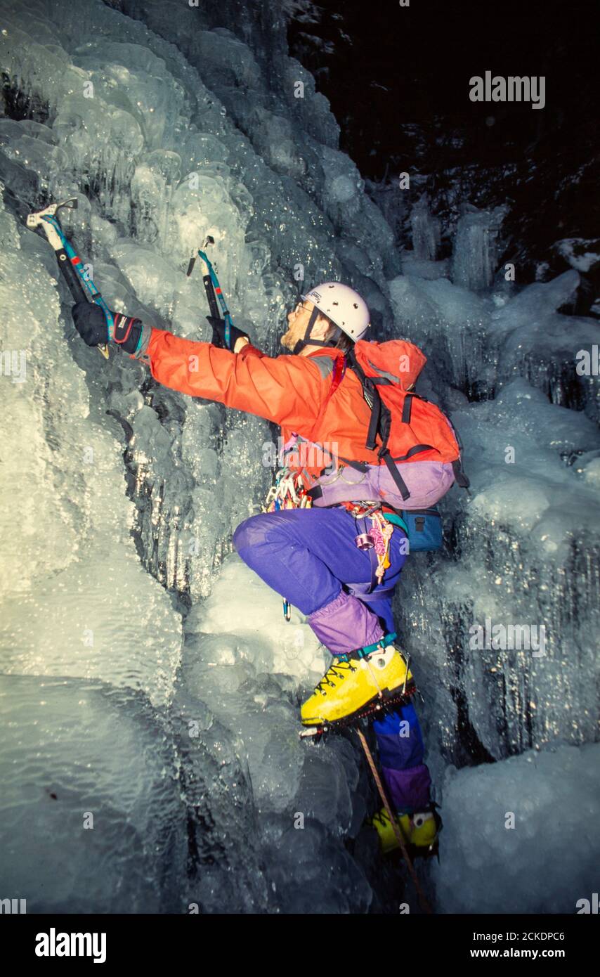 A mountaineer ice climbing in the Lake District, UK at night Stock