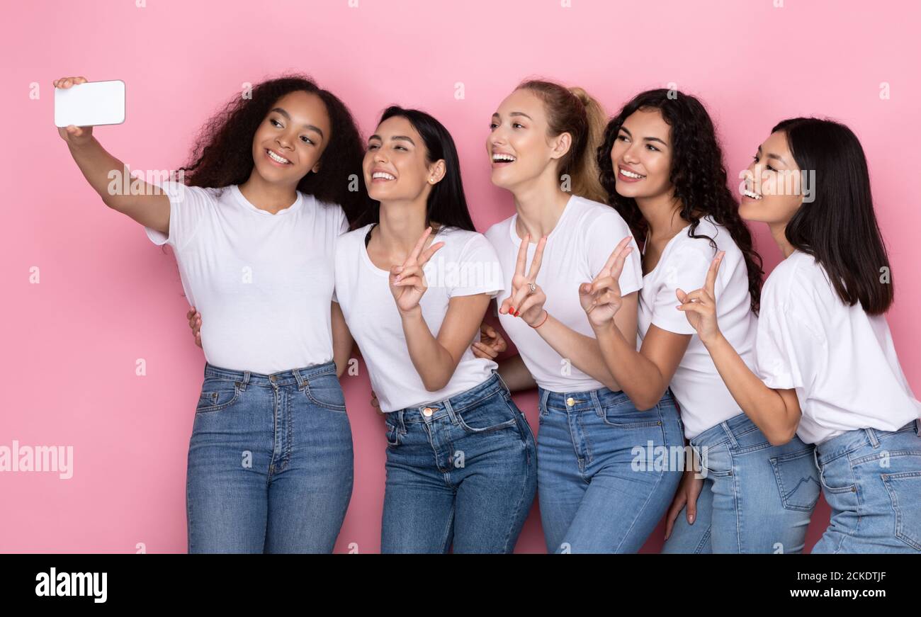 Group Of Young People Holding Their Friend Girl On Hands In Front Of Them  Posing To Camera And Laughing, Standing Indoors In Warm Light Stock Photo,  Picture and Royalty Free Image. Image