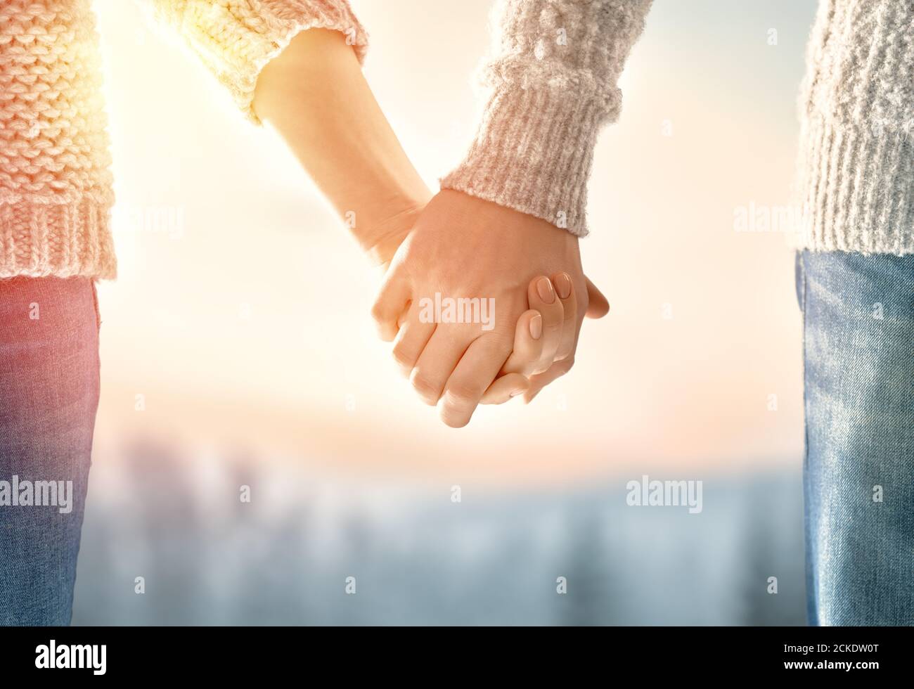 Couple on Valentines day. Woman and man holding hands Stock Photo - Alamy