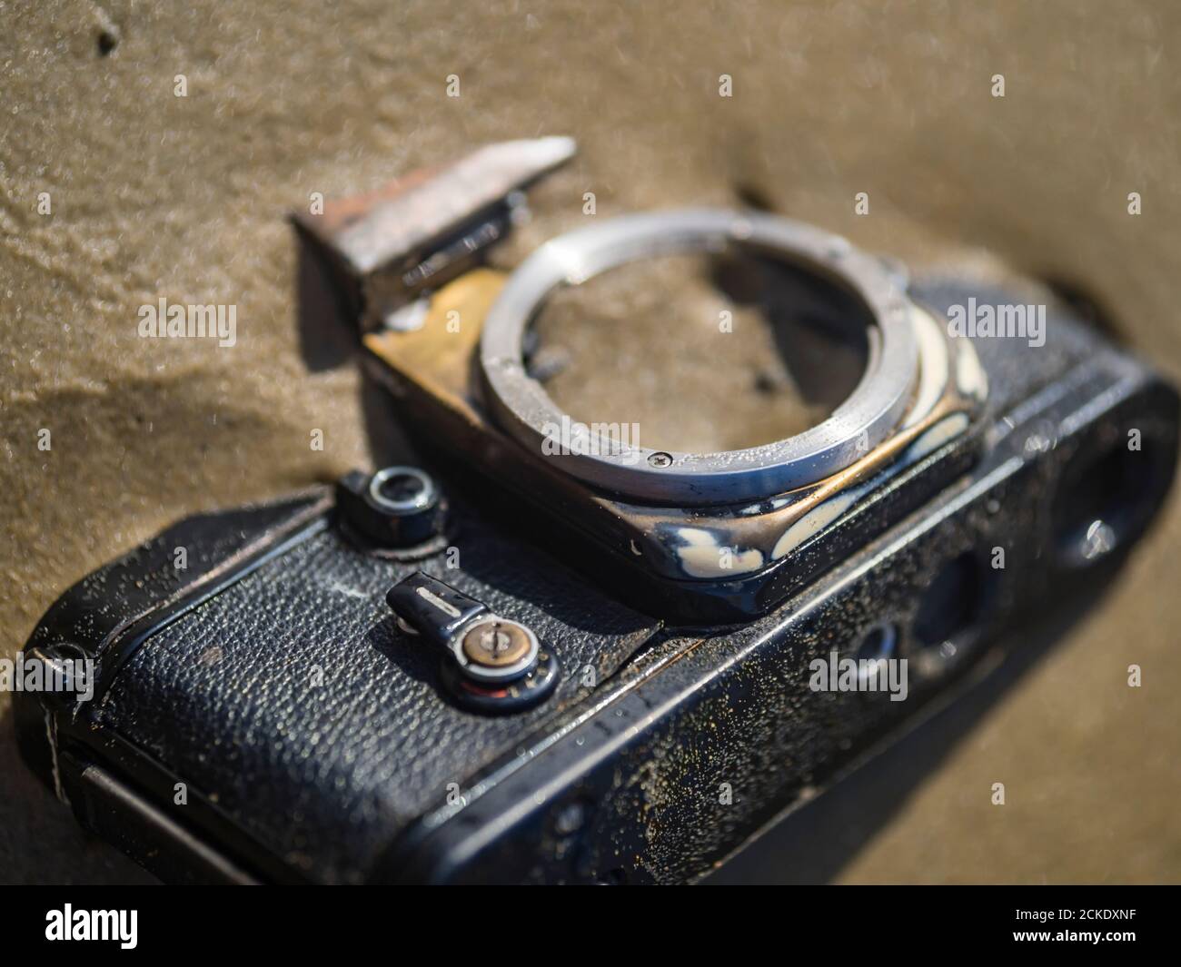 Nikon retro classic SLR film camera body on beach closeup close-up detail details crop cropped view Stock Photo