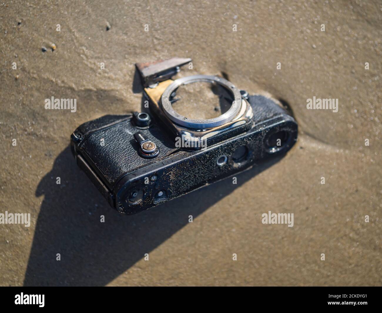 Nikon retro classic SLR film camera body on beach Stock Photo