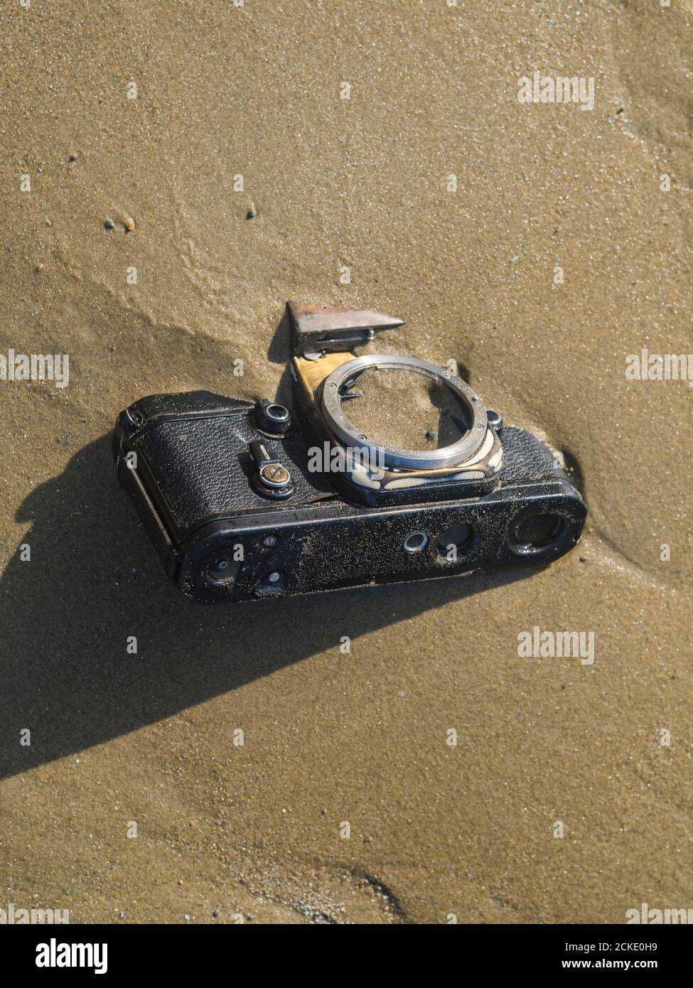 Nikon retro classic SLR film camera body on beach Stock Photo