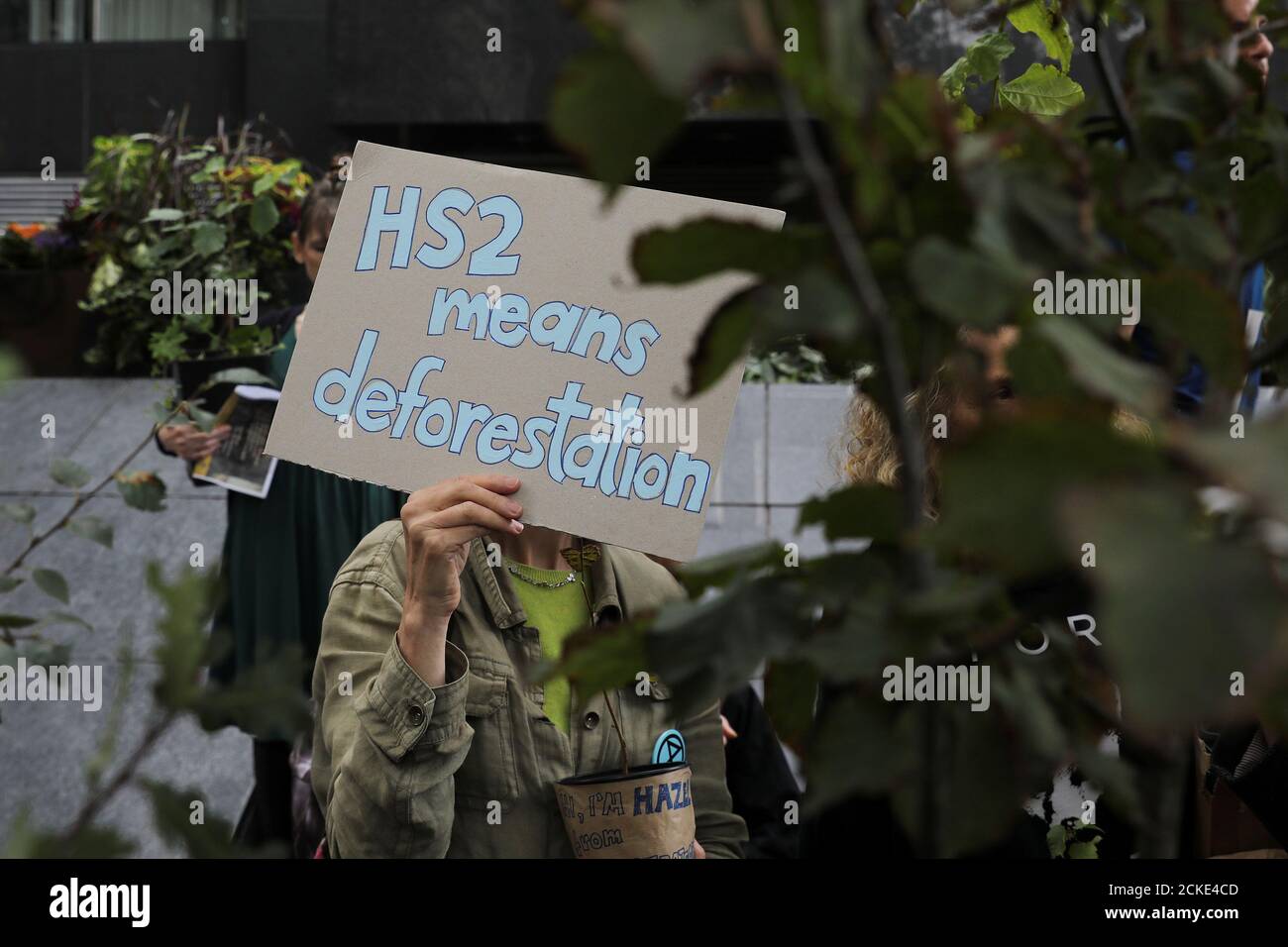 An anti-HS2 protester holds a placard as she demonstrates outside the High Speed 2 headquarters at Euston Station in London, Britain September 28, 2019. REUTERS/Simon Dawson Stock Photo