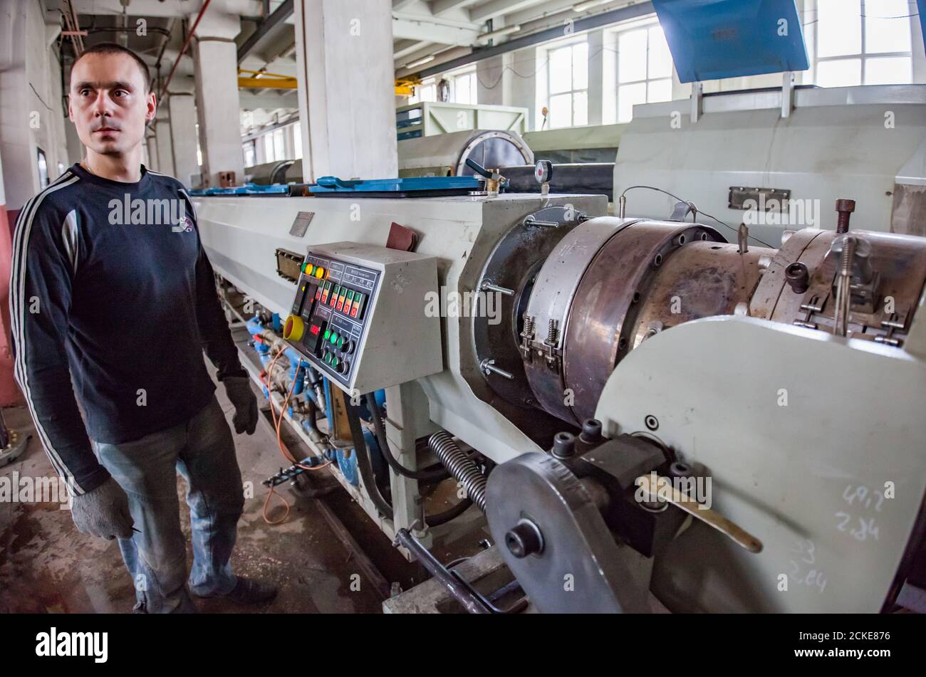 Modern plastic pipes production line. Operator worker controlling process Stock Photo Alamy