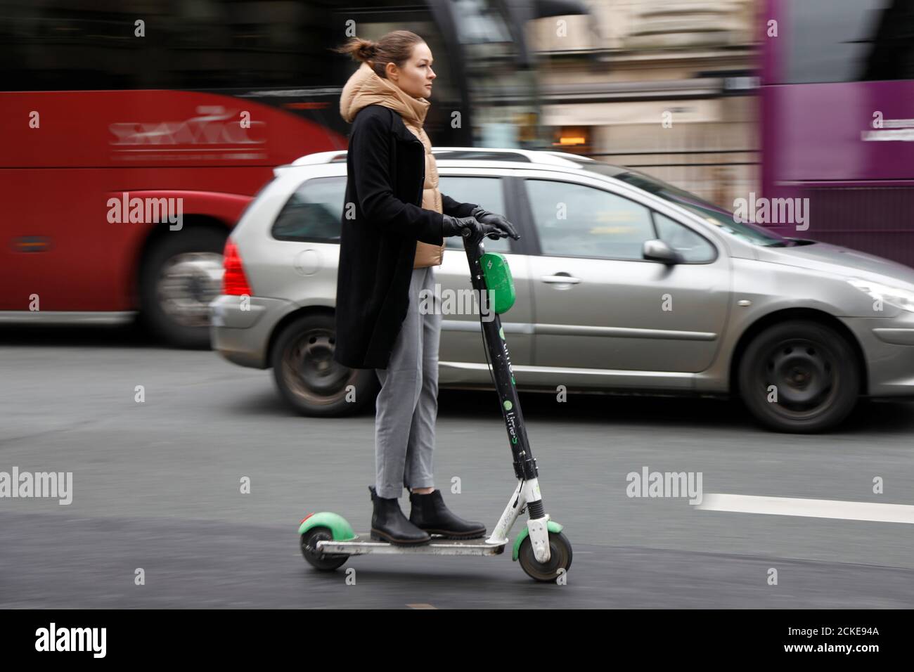 A Woman Rides A Dock Free Electric Scooter Or Trotinette Lime S By California Based Bicycle Sharing Service Lime In A Street Of Paris As A Strike By All Unions Of The Paris Transport Network