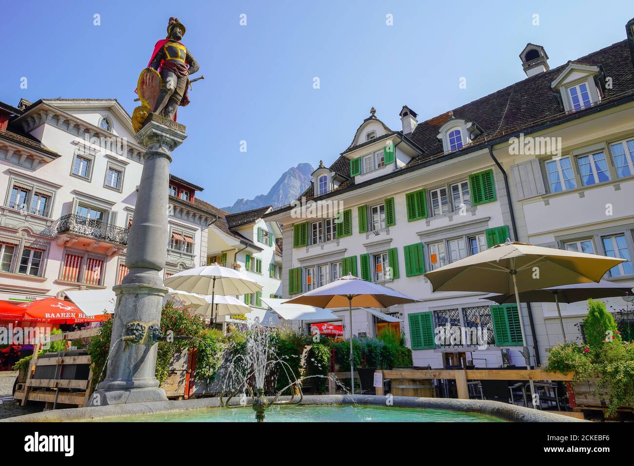 Fountain (Brunnen-Mandl)  in the central plaza in Schwyz. The medieval town  Schwyz is the capital of the canton of Schwyz in Switzerland. The Federa Stock Photo