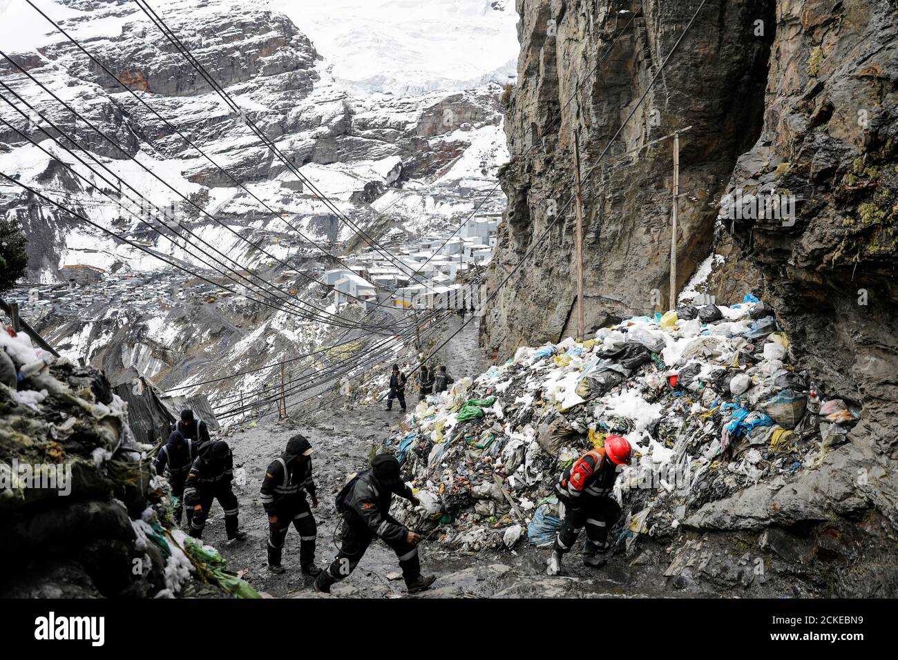 Men Who Work As Miners Walk In Front Of La Bella Durmiente The Sleeping Beauty Glacier As They Exit A Gold Mine After Finishing Work For The Day In La Rinconada The