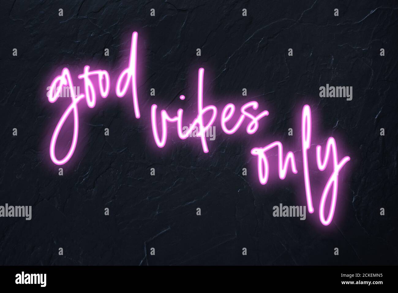 Good vibes only written in pink neon style on black wall background Stock Photo